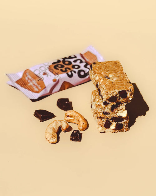 Crunchy Choc Chip snack bar with its wrapper, chocolate chunks, and cashews